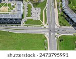 city roads intersection in residential area. aerial top view of crossroad in summer sunny day.