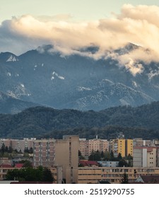 city scape with mountains in background and dramatic sky