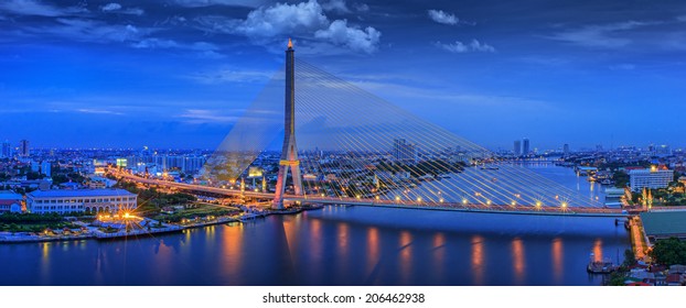 City scape of Rama VIII Bridge at night in Bangkok and Chopraya river, Thailand