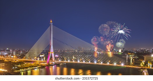 City scape of Rama VIII Bridge at night in Bangkok and Chopraya river and fireworks Festival , Thailand