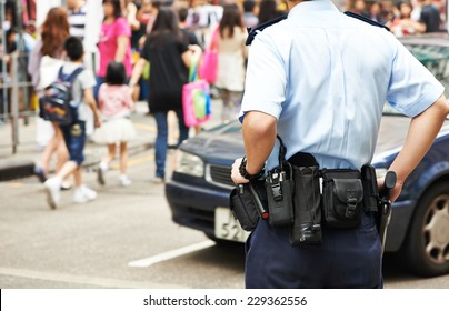 City Security. Policeman Watching Order In The Urban Street 