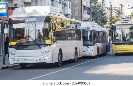 City Shuttle Buses At A Stop On The Street In The City