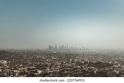 City skyline, of the bustling metropolis of Los Angeles, California during summer. Big skyscraper buildings are popping up in the hazy atmosphere of L.A. on Mulholland Scenic Overlook in the USA. - Powered by Shutterstock