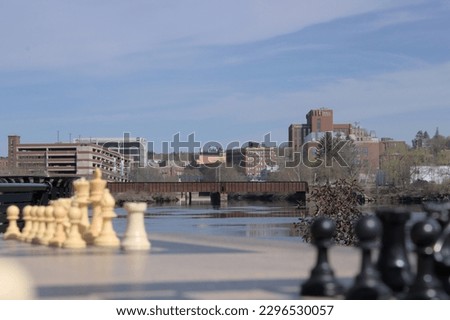 City skyline with chess pieces in the foreground 