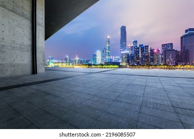 City skyline and modern commercial buildings with empty square floor in Guangzhou at night, China.