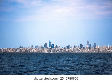 City skyline seen from the sea with tall buildings under a bright sky. Coastal urban landscape showcasing a modern metropolis vibe - Powered by Shutterstock