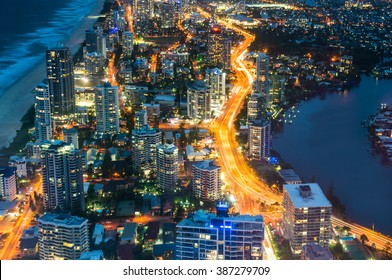 City Skyscrapers And Busy Highway Traffic At Night, Aerial, Long Exposure. Futuristic Cityscape, Surfers Paradise, Gold Coast, Queensland, Australia