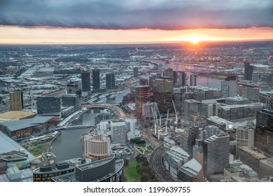 City Skyscrapers And Yarra River Aerial View At Sunset From High Point Of View, Melbourne.