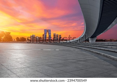 City square and skyline with modern buildings sunset in Suzhou, Jiangsu Province, China. Empty square floor and city skyline background.