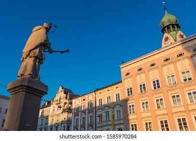 city square with statue and facades in rosenheim, bavaria