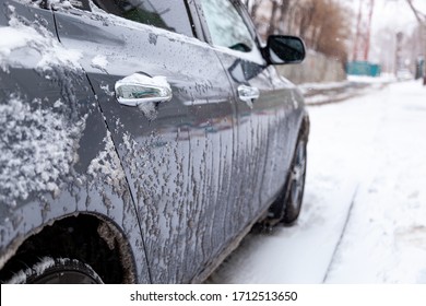 City Street After Cyclone And Heavy Snowfall. Car Under The Snow. Ice On A Car Body. Inclement Weather. Sudden Snowfall In Late Spring. Warm Winter.