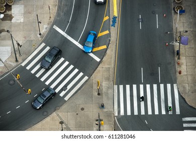 City street with crosswalks on asphalt road and car traffic. Fast city life transportation concept.
