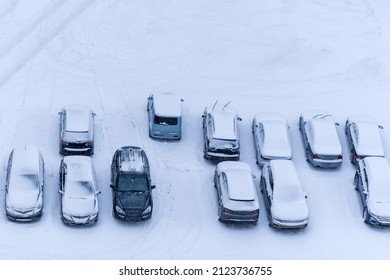 City Street Driveway Parking Lot Spot With Small Car Covered Snow. Extreme Weather Conditions. Selective Focus