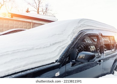 City Street Driveway Parking Lot Spot With Small Car Covered Snow Stuck Trapped After Heavy Blizzard Snowfall Winter Day By Big Snowy Pile. Snowdrifts And Freezed Vehicles. Extreme Weather Conditions