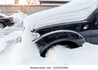 City Street Driveway Parking Lot Spot With Small Car Covered Snow Stuck Trapped After Heavy Blizzard Snowfall Winter Day By Big Snowy Pile. Snowdrifts And Freezed Vehicles. Extreme Weather Conditions