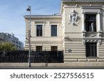 City street and exterior building architecture on the Victory Avenue in Bucharest city, capital of Romania