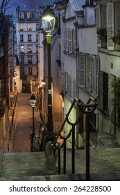 City Street In Montmartre Area Of Paris, France At Night