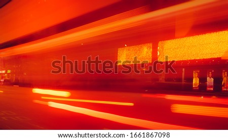 City street in the night with blurred fast speed car light. Red and yellow light at the rod beside the building. Night light abstract background. Blurred motion of light on the road.
