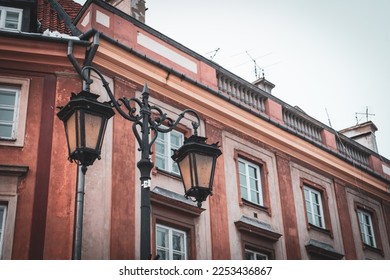 City street of old town in Warsaw. Narrow sunny street between colorful buildings of old town - Shutterstock ID 2253436867