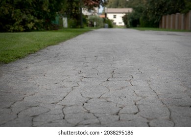 City Street View With Old Cracked Asphalt Pavement.