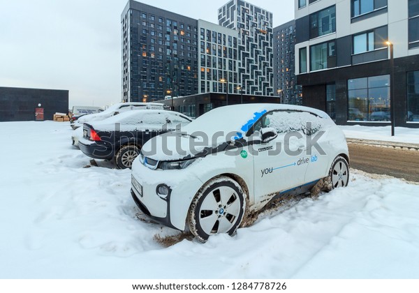 City\
subcompact auto BMW i3 with logos of  company operator Youdrive\
Carsharing. Electric car parked in snowy parking lot in courtyard\
of residential complex. Moscow - January,\
2019