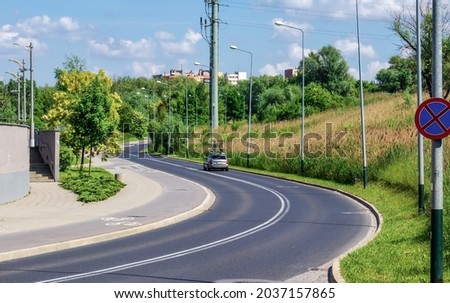 city summer landscape, asphalt road in the city, turn, the car moves on the highway