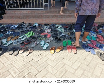 City Of Surabaya, State Of Indonesia.  July 8, 2022. Slippers Are Neatly Arranged In Front Of The Mosque And Worshipers Walk Into The Mosque.