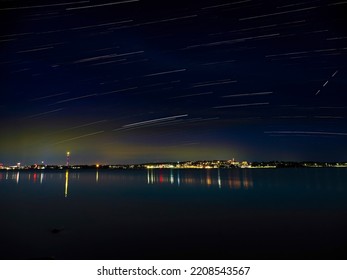 City Of Tampere By Night And Star Trails In The Sky.