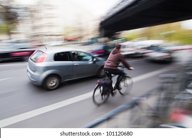 City Traffic With A Cyclist And Cars In Motion Blur