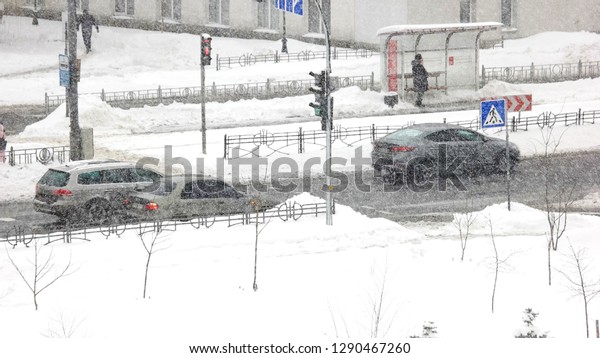 City traffic\
in winter time. Timelapse of car traffic on the road during snow\
storm in winter city. Winter city\
life.