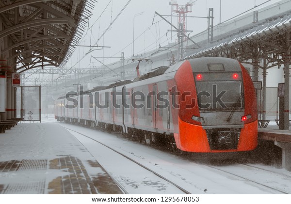 City train in the\
snow