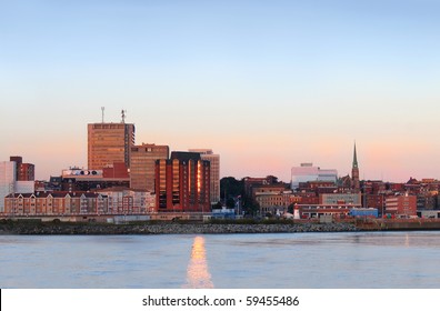 City View Of Dowtown Area Of Saint John, New Brunswick, Canada At Sunset With Sun Reflections In The Water From Buidling