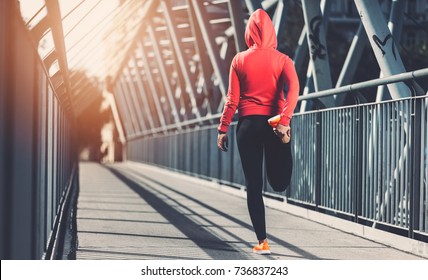 City workout. Beautiful young woman training in an urban setting - Shutterstock ID 736837243