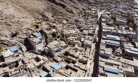 City of Xigaze at Tibet from the sky. A aerial view over a small Tibetan village in the mountain of the Himalayas. Drone view over the roof of Shigatse, Tibet, China. Small houses and narrow streets 