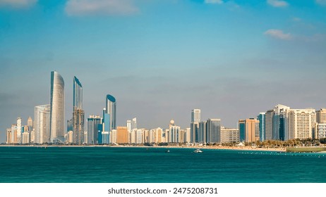 Cityscape of Abu Dhabi marina timelapse at Persian Gulf, UAE. Abu Dhabi is the capital and the second most populous city in the United Arab Emirates. Blue cloudy sky - Powered by Shutterstock