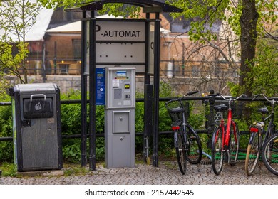 Cityscape background. City car parking equipped with automatic payment machine, garbage container and holders for bicycles. Sweden. Uppsala. 05.14.2022.