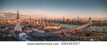 Cityscape of Bratislava, Slovakia with St. Martin's Cathedral and Danube River with New Bridge at Sunset