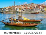Cityscape of the city of Porto, Douro river with its old boat and its typical colored houses on the water
