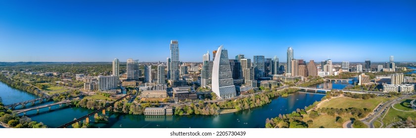 Cityscape and Colorado River against the blue sky in a panoramic view. There are bridges over the river at the front and a view of skycrapers at the back. - Shutterstock ID 2205730439