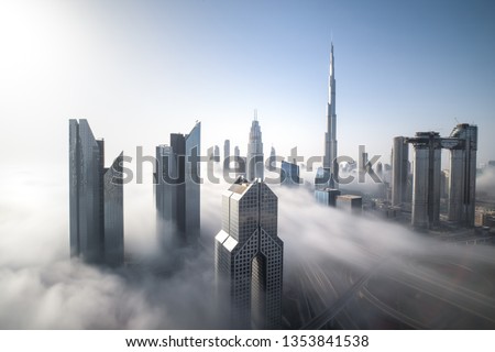 Cityscape of Dubai Downtown skyline on a foggy winter day. Dubai, UAE.