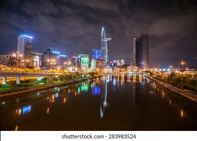 Cityscape Of Ho Chi Minh At Night With Bright Illumination Of Modern Architecture, Viewed Over Saigon River In Southern Vietnam.