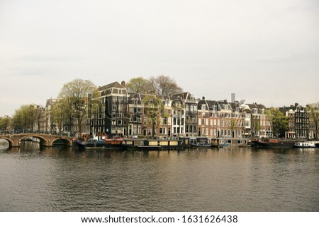 Similar – Image, Stock Photo Tranquil Amsterdam canal with iconic narrow houses