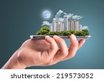 Cityscape intelligent building ,hold smart phone for build and make your green city.