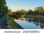 Cityscape with the Lopan River and embankment on a summer evening. Kharkiv city, Ukraine