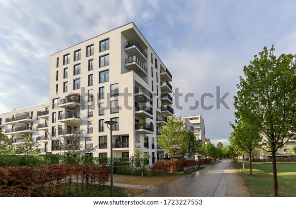 Cityscape of a modern\
residential area with apartment buildings, new green urban\
landscape in the city