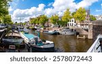 Cityscape with old, colourful boats along canal A in the historic city centre of Groningen, Netherlands