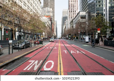 Cityscape With Red Driveway With Tram Rails In San Francisco In California USA. There Are People, Cars And Bicycles On The Street. Horizontal.