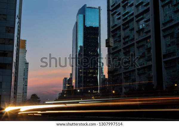 Cityscape in Santa Fe,\
Mexico City with light trails  taken with a long exposure during\
the sunset. 