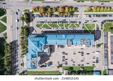 Cityscape At Sunny Day. Office Building And Parking Lots With Parked Cars. Aerial Top View.