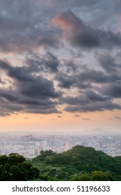 Cityscape of sunset with dramatic clouds on sky.